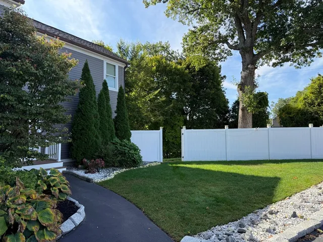a view of a house with a backyard