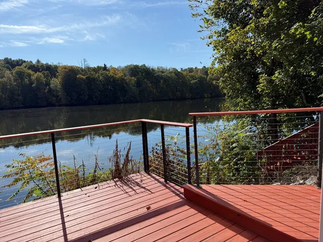 a view of balcony with wooden floor and lake view