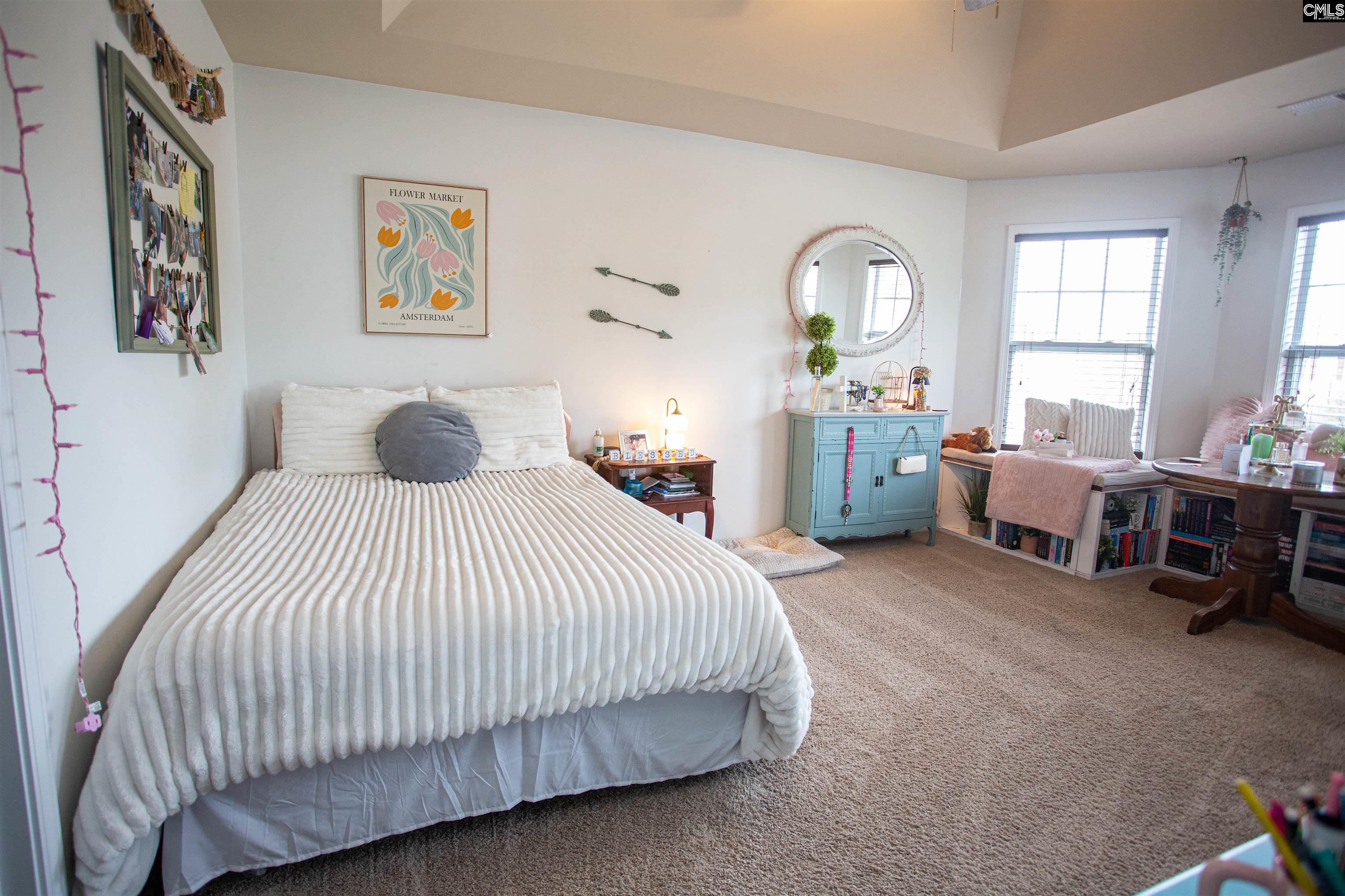 7 Templand Court Elgin, SC 29045 - Photo 43 of 47 a spacious bedroom with a bed a couch and a window