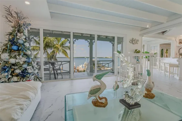 a bedroom with a bed a flat screen tv and a chandelier