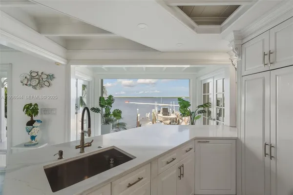 a spacious bedroom with a bed a couch and a chandelier