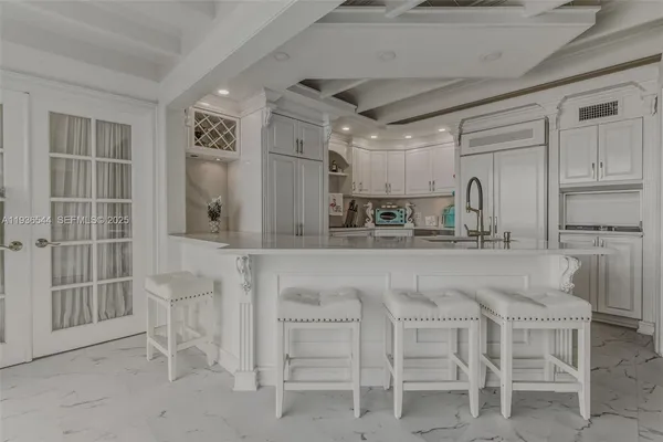 a bedroom with a bed and a flat tv screen on dresser