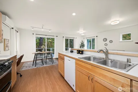 a kitchen with furniture wooden floor and a sink