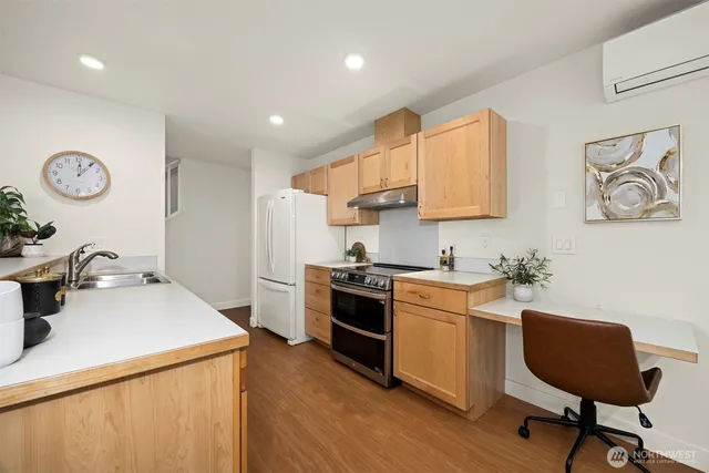 a kitchen with a sink cabinets and wooden floor