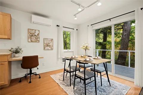 a view of a livingroom with furniture window and wooden floor