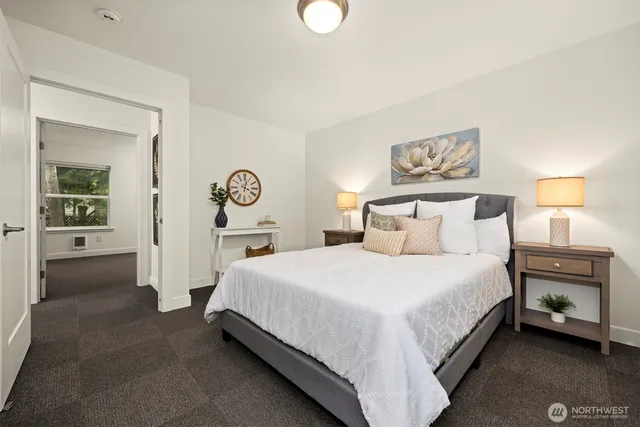 a bedroom with a bed and a lamp