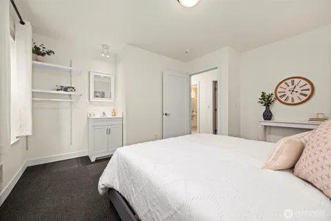 a spacious bedroom with a bed and a cabinets