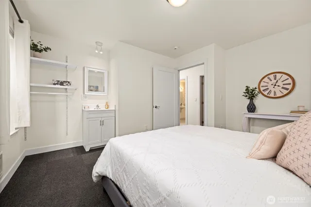 a spacious bedroom with a bed and a cabinets