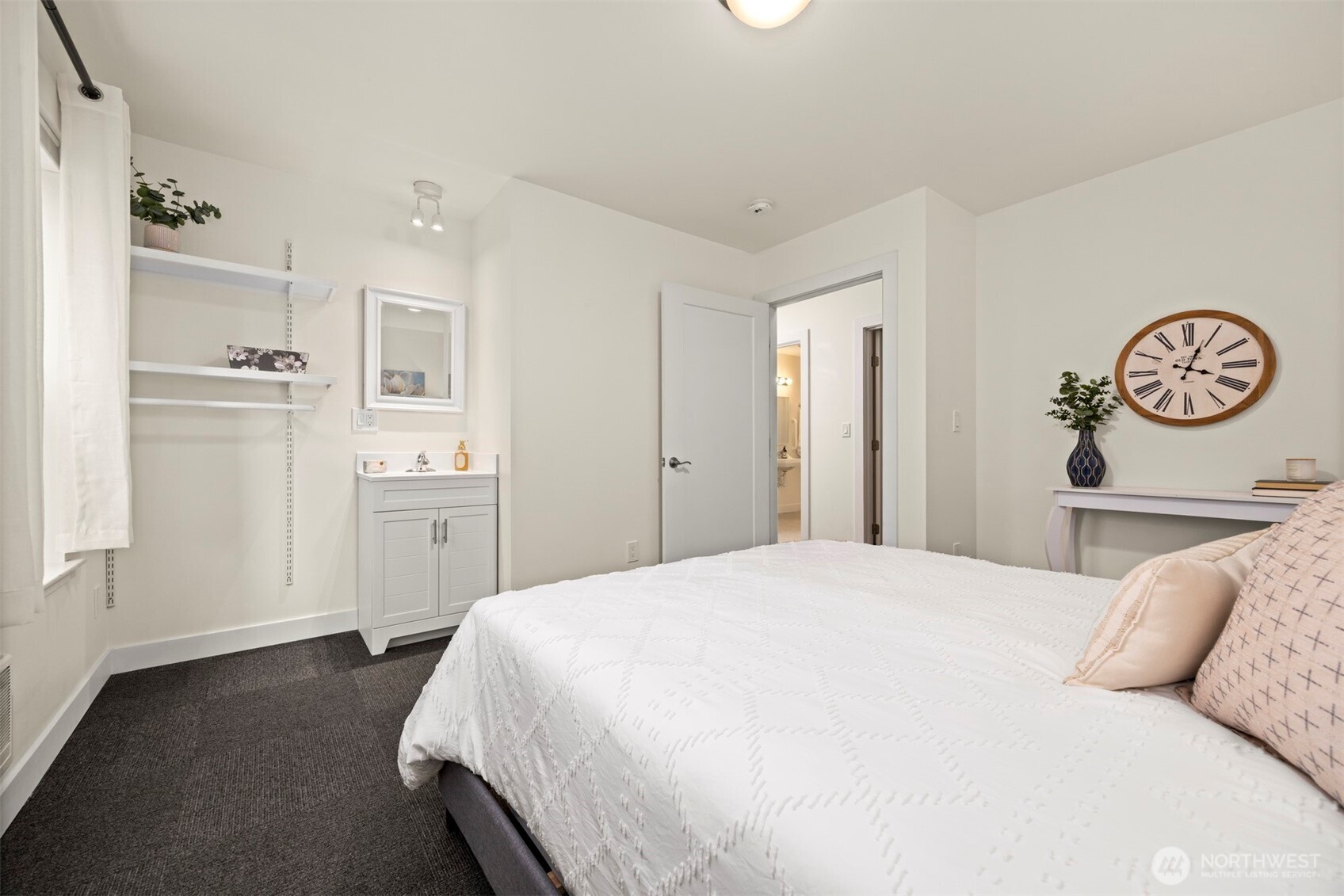 1416 32nd Street Bellingham, WA 98225 - Photo 24 of 37 a spacious bedroom with a bed and a cabinets