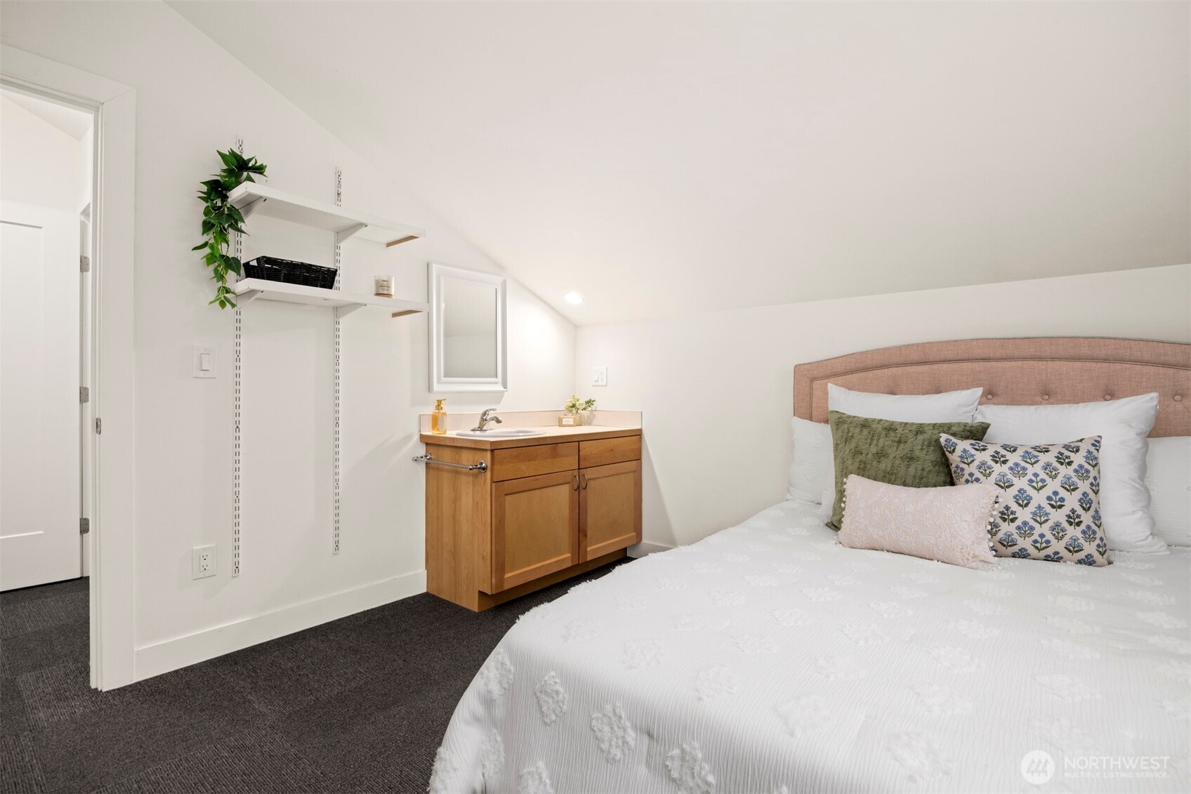 1416 32nd Street Bellingham, WA 98225 - Photo 26 of 37 a bedroom with a bed and a chandelier