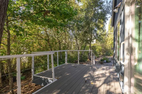 a view of balcony with wooden floor and fence