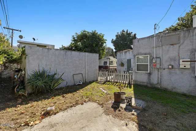 a backyard of a house with table and chairs