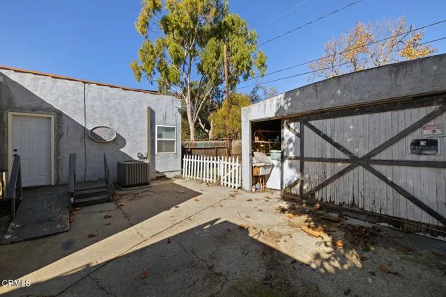 a view of a house with a tree beside it