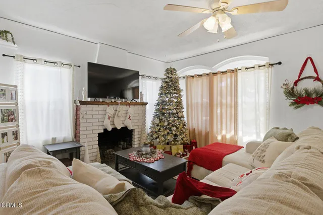 a living room with furniture fireplace and flat screen tv