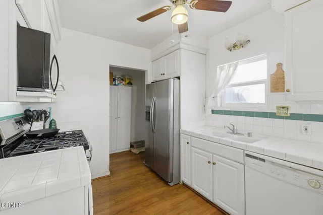 a kitchen with a sink stove and refrigerator