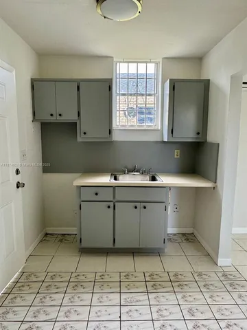a room with a cabinets and window