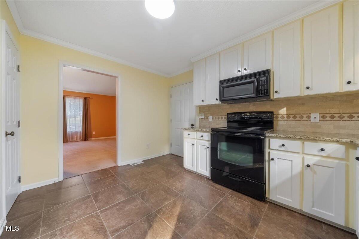 620 Trunecek Circle Raleigh, NC 27603 - Photo 8 of 53 a kitchen with a sink and a stove top oven