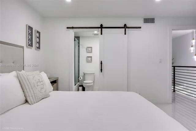 a bedroom with a bed and a table
