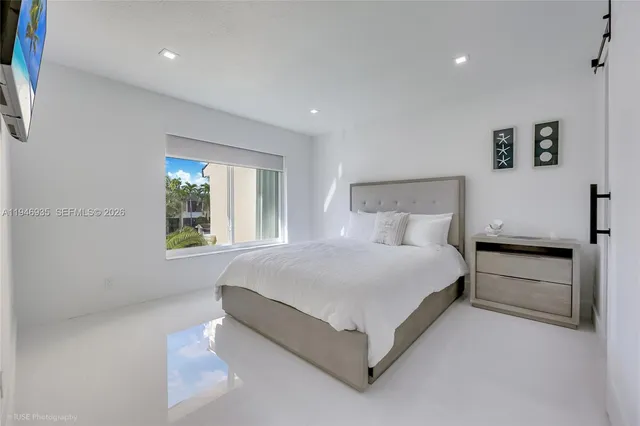 a bed room with a bed and a night stand