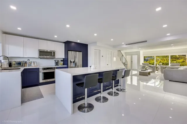 a kitchen with a sink dining table and chairs