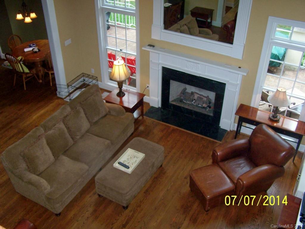 2405 New Salem Road Monroe, NC 28110 - Photo 13 of 20 a living room with furniture a fireplace and a floor to ceiling window