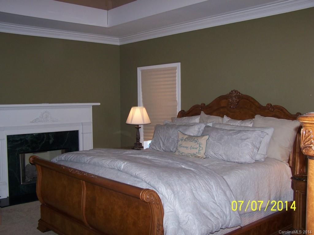 2405 New Salem Road Monroe, NC 28110 - Photo 9 of 20 a bedroom with a bed and a fireplace