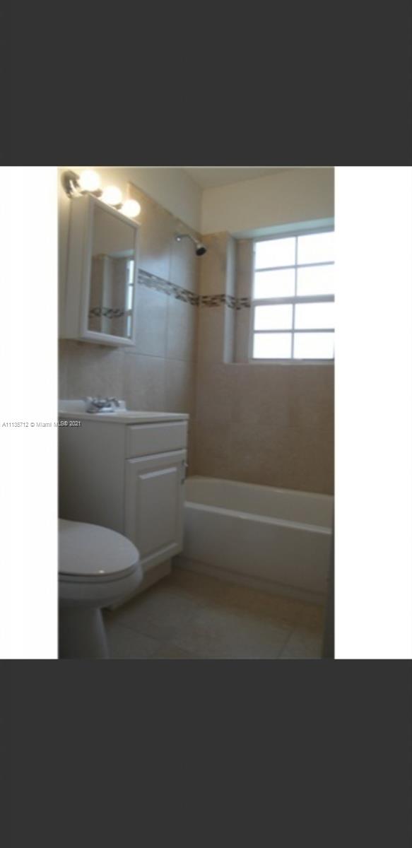 5566 South Rue Road West Palm Beach, FL 33415 - Photo 9 of 10 a bathroom with a toilet and a shower