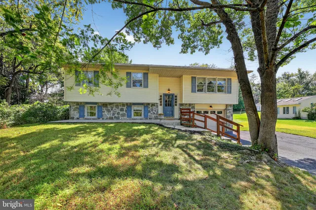 a view of a house with pool and chairs