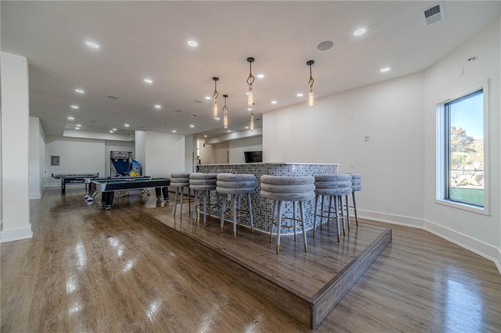 494 River Overlook Road Dawsonville, GA 30534 - Photo 12 of 90 an open kitchen with a table and chairs