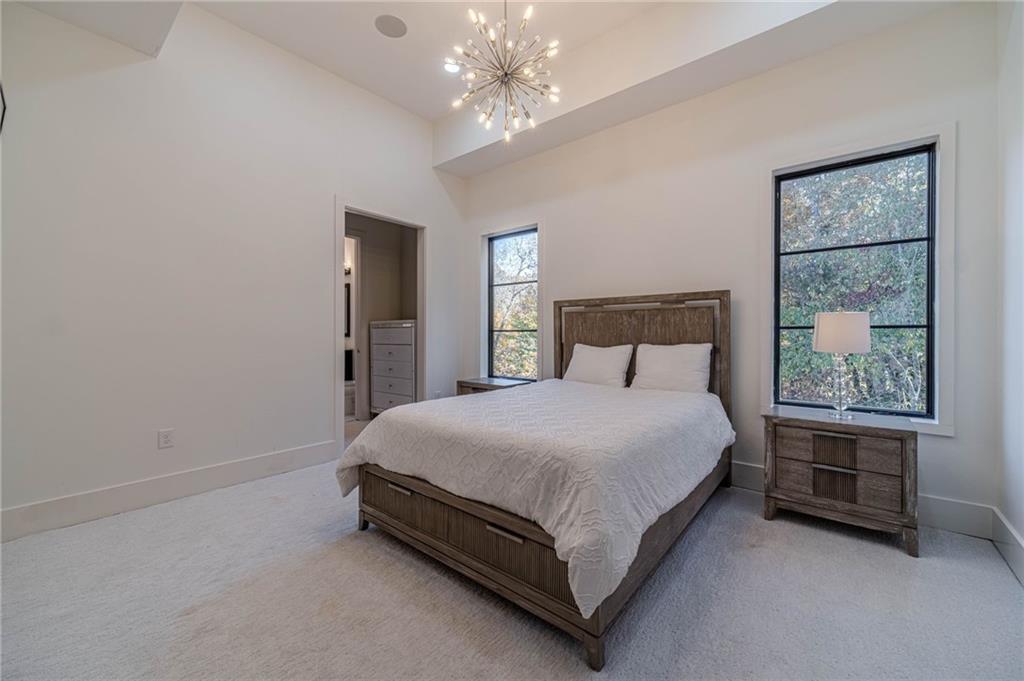494 River Overlook Road Dawsonville, GA 30534 - Photo 22 of 90 a bed sitting in a spacious bedroom next to a window
