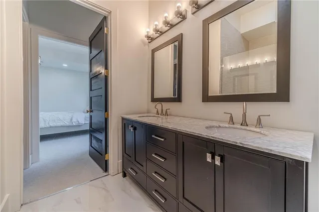 a spacious bedroom with a bed a table and chairs