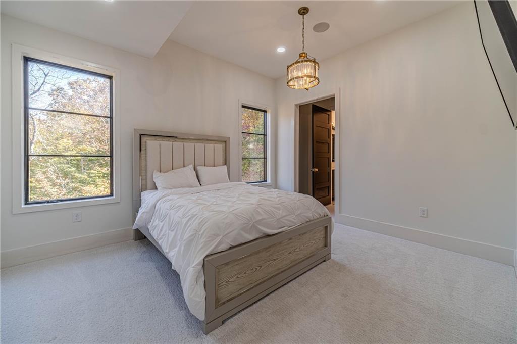 494 River Overlook Road Dawsonville, GA 30534 - Photo 25 of 90 a spacious bedroom with a bed and a window