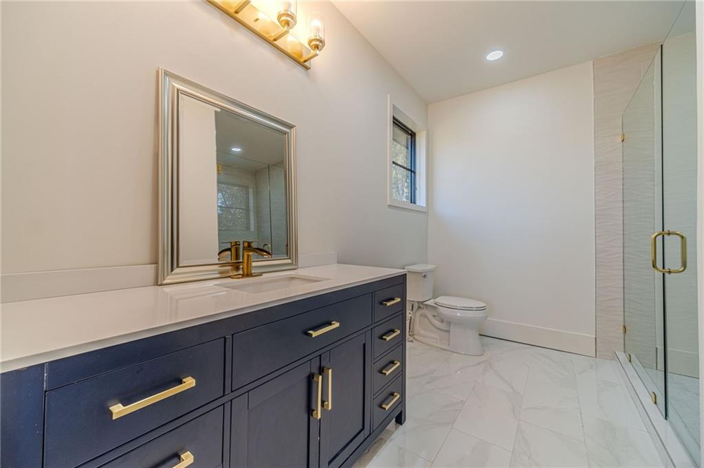 494 River Overlook Road Dawsonville, GA 30534 - Photo 27 of 90 a bathroom with a sink a toilet a mirror and vanity