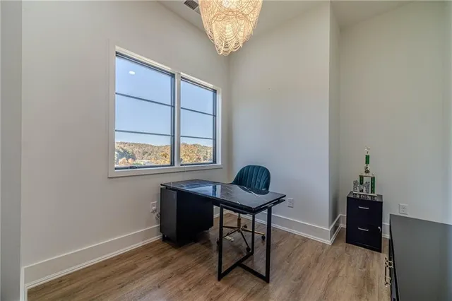 a spacious bedroom with a bed and a large window