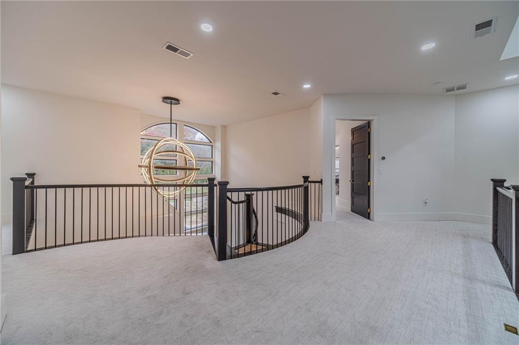 494 River Overlook Road Dawsonville, GA 30534 - Photo 31 of 90 a view of a hallway with chandelier