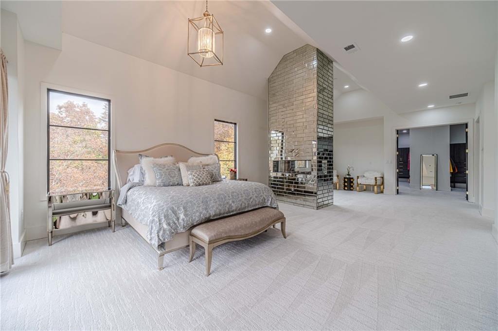 494 River Overlook Road Dawsonville, GA 30534 - Photo 35 of 90 a spacious bedroom with a bed a table and chairs