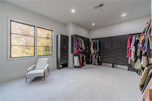 a living room with furniture and a dresser