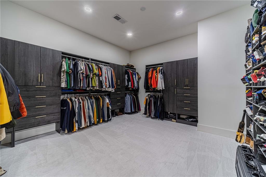 494 River Overlook Road Dawsonville, GA 30534 - Photo 42 of 90 a view of walk in closet with clothes and shoes