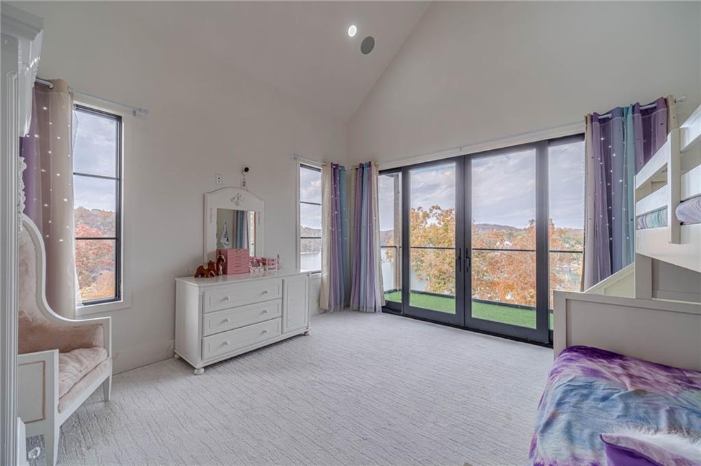 494 River Overlook Road Dawsonville, GA 30534 - Photo 48 of 90 a spacious bedroom with a bed and a large window