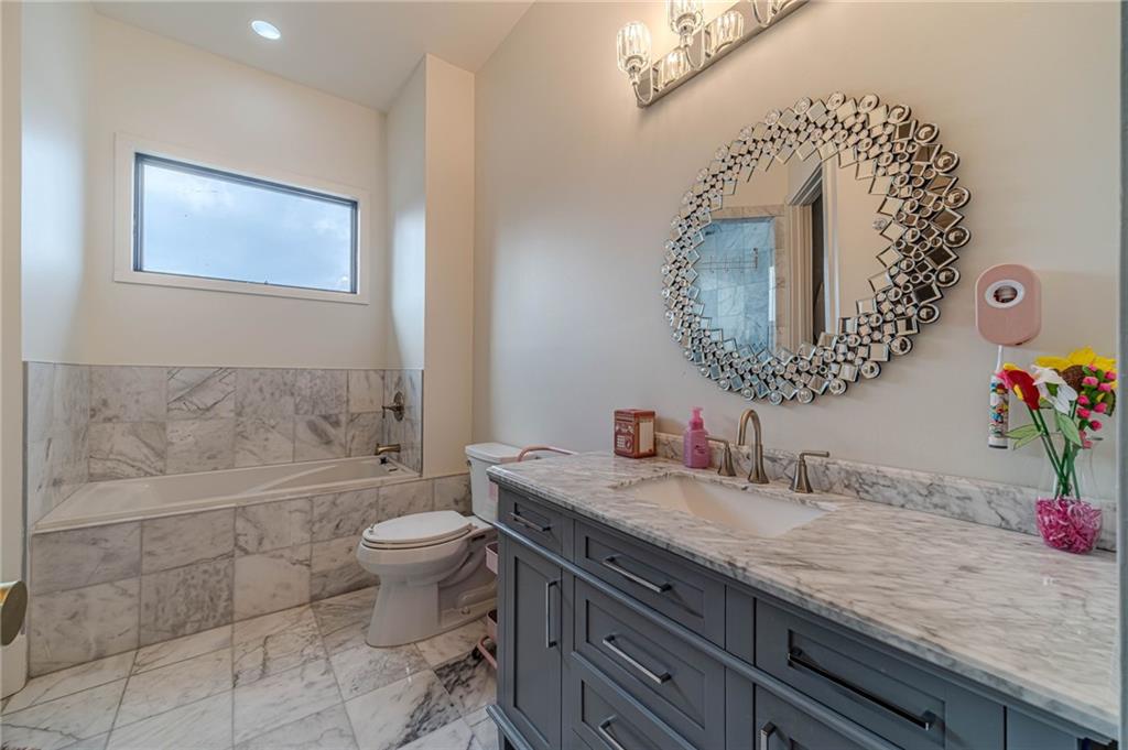 494 River Overlook Road Dawsonville, GA 30534 - Photo 49 of 90 a bathroom with a granite countertop sink mirror vanity and toilet