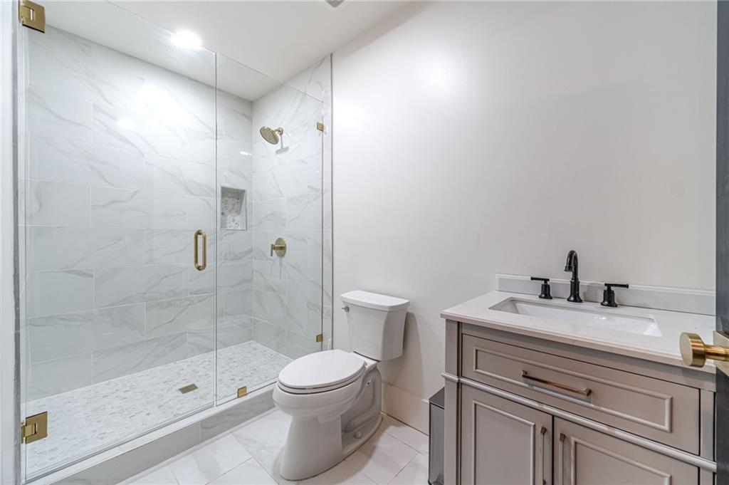 494 River Overlook Road Dawsonville, GA 30534 - Photo 65 of 90 a bathroom with a sink a toilet and shower