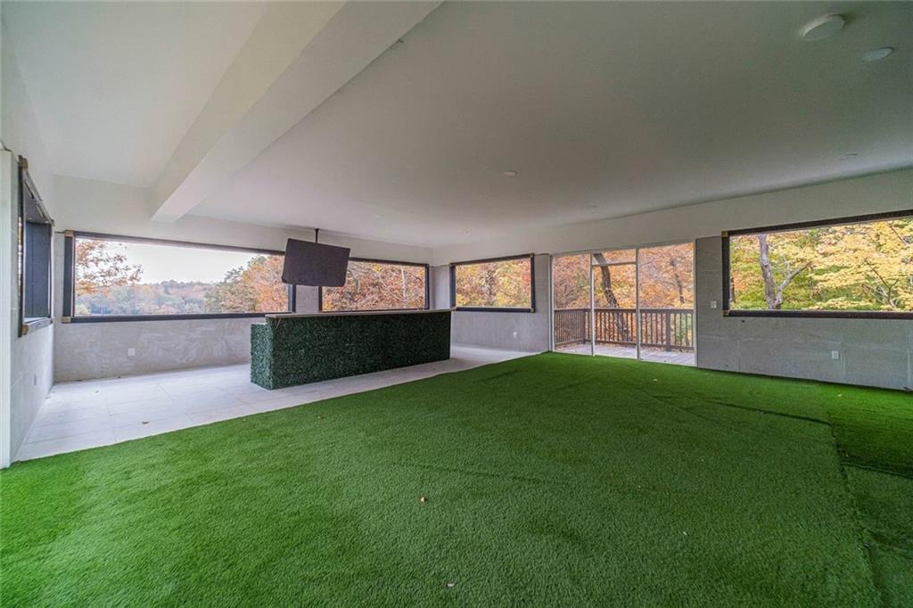494 River Overlook Road Dawsonville, GA 30534 - Photo 70 of 90 a view of an empty room with a window and wooden floor