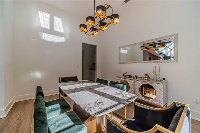 a kitchen with a stove and a wooden floor