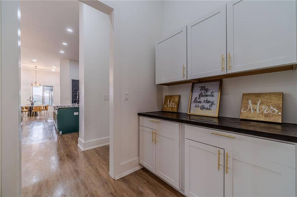 494 River Overlook Road Dawsonville, GA 30534 - Photo 8 of 90 a kitchen with stainless steel appliances granite countertop a refrigerator a sink and white cabinets with wooden floor