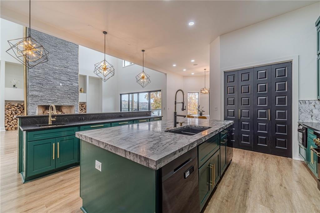494 River Overlook Road Dawsonville, GA 30534 - Photo 10 of 90 a kitchen with a stove and a wooden floor