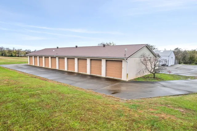 a view of a house with swimming pool and sitting area