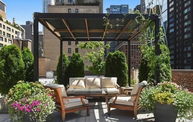 a view of a patio with table and chairs and potted plants