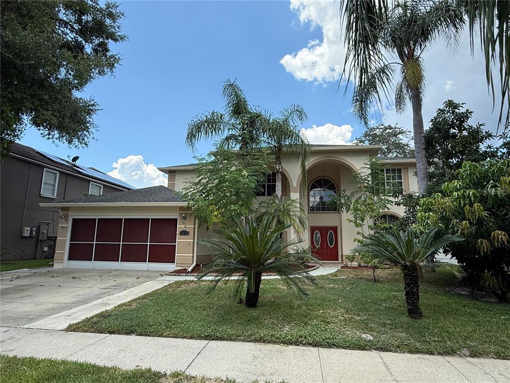 a front view of a house with a yard and garage