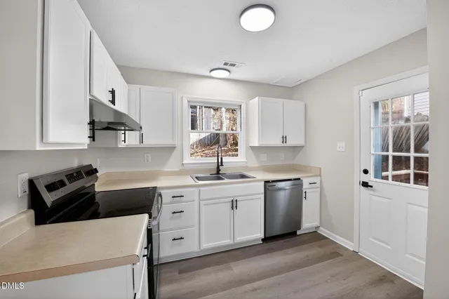 a kitchen with a sink a stove and refrigerator