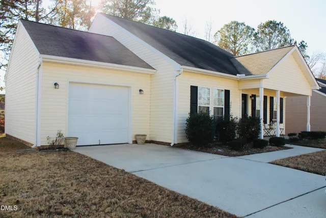 a view of house with backyard